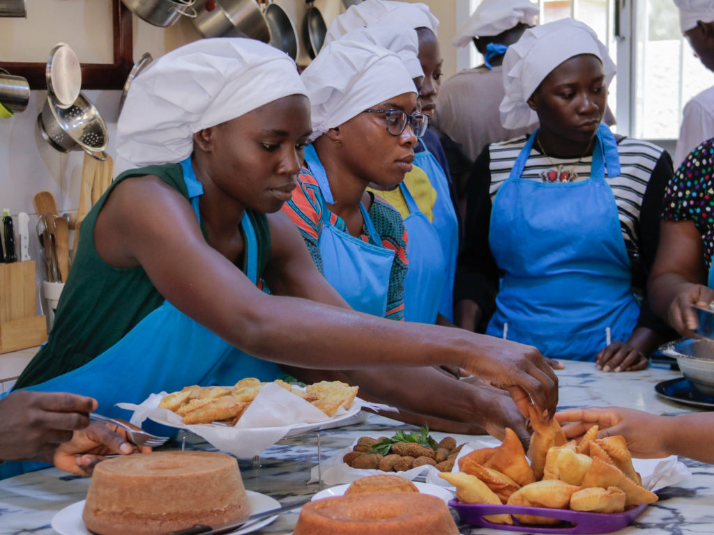 Three young women take part in skills training in cookery through an SOS Children's Villages programme in Guinea